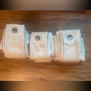 Eight 36x81 cream colored grommet curtains